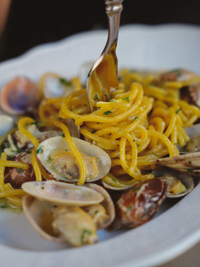 A close-up shot of delicious seafood pasta with clams, perfect for fine dining imagery.